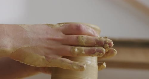 Hands Shaping Clay on a Pottery Wheel