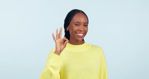 Woman Smiles and Makes Okay Hand Gesture