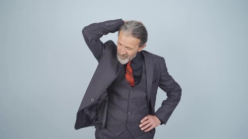 Mature Man Puts On Suit Coat