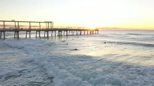 Surfers aerial with nice move, freestyle and fresh ocean blues. Amazing aerial of surfer at sunrise