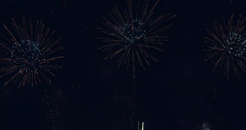Loop seamless of real fireworks light up the sky with dazzling display in the night sky. 4KDCI