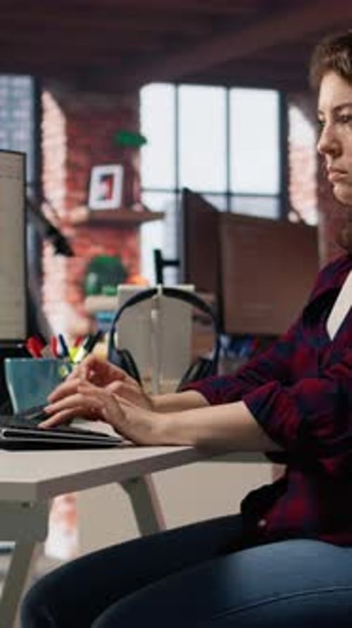 Woman Works on Laptop at Modern Office Desk