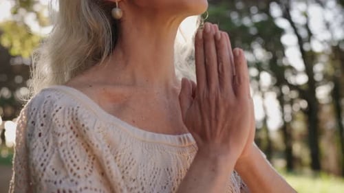 Woman Meditating Peacefully in Forest Sunlight