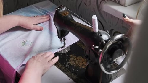 Woman Sewing Fabric on Antique Machine