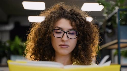Young Woman Studying for Exams at University Class