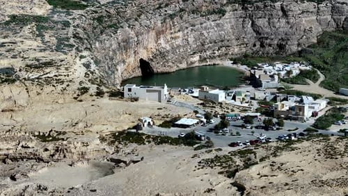 An aerial high angle shot reveals the sun drenched Inland Sea at Dwejra in Gozo Malta where