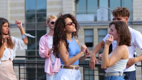 Group of Friends Dancing on Rooftop in City