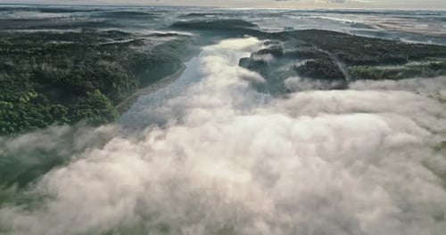 Aerial view of lake with fog in autumn at sunrise.