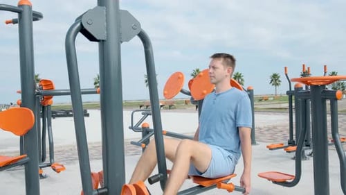 Active Man Exercising at Outdoor Gym Young Male Doing Leg Muscle Exercises on Street Playground