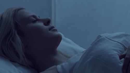 Sleeping Woman with Blonde Hair in Bed at Night