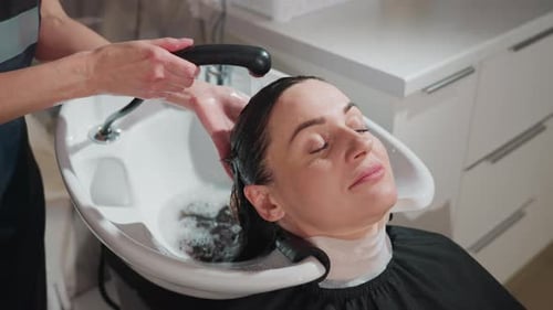 Woman Getting Hair Washed at Salon Headshot