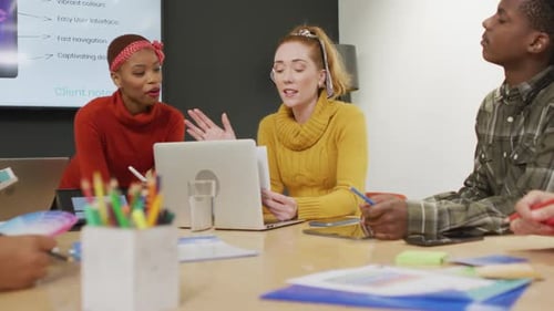 Happy diverse business people discussing work during meeting at office