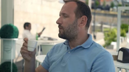 Happy Man Drinking Espresso in Cafe in City 30s