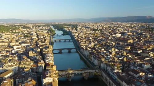 High Aerial Flight Over Arno River and Ponte Vecchio Bridge