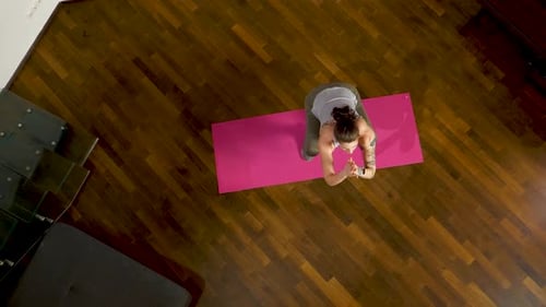 Woman Exercising, Stretching on Mat at Home