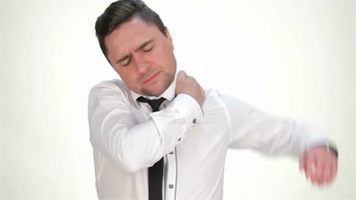 Man Massaging Sore Neck and Shoulder in Studio