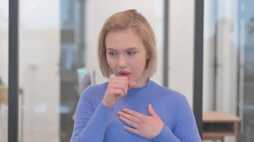 Portrait of Coughing Sick Young Woman in Office