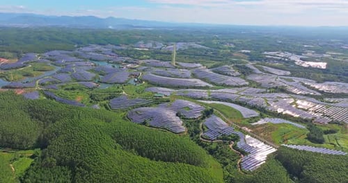 Aerial View of Extensive Solar Panel Farm Landscape