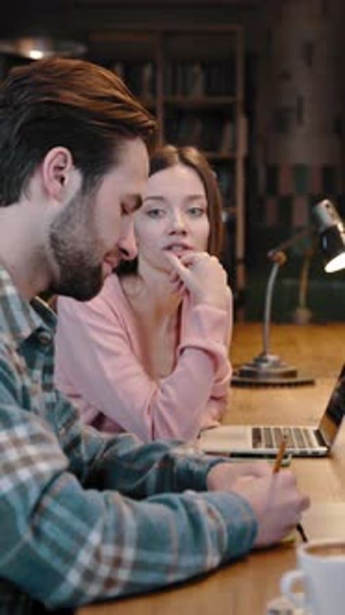 Confident Young Woman Works in Library Together with Multiethnic Coworkers