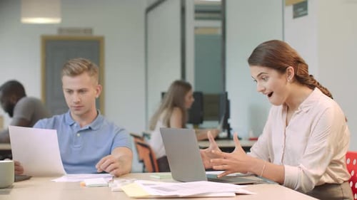 Woman Celebrates Success at Work in Office