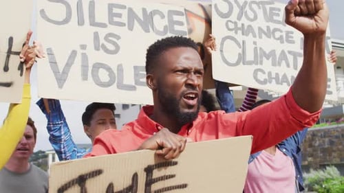 Diverse Group Protesting with Signs on Urban Street