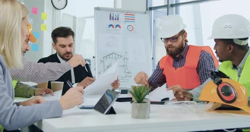 Man and woman engineers and customer brainstorming together about building project during meeting