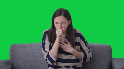 Sick Indian girl suffering from cold and cough Green screen