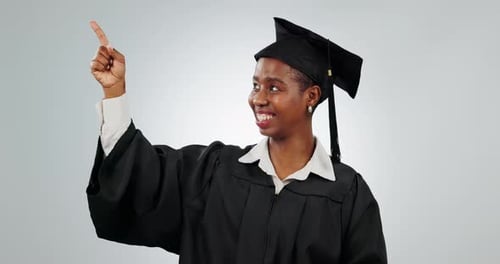 Woman, graduation and student pointing finger in studio for school and education advertising