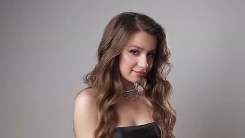 Glamorous Woman Posing with Wavy Brown Hair