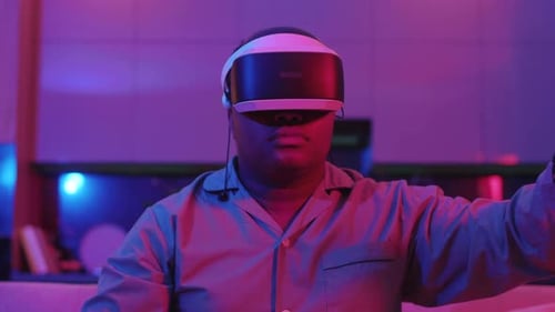 Man Wears VR Headset and Interacts with Interface