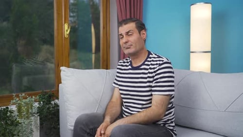 Emotional man watching outside the window.