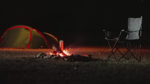 Campsite with Tent and Campfire at Night