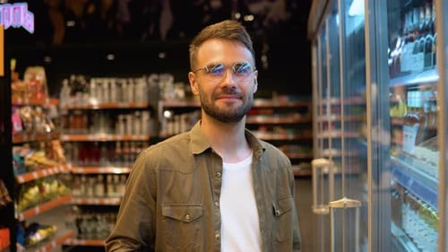 Portrait of a Man at Supermarket Man Choosing the Right Product in a Supermarket