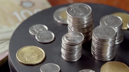 Stack of Canadian Currency Coins Rotates in a Circle Growing Business