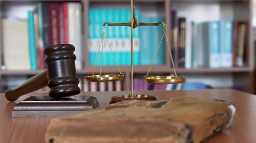 Scales of Justice Gavel and Book in a Library