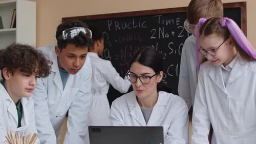 Female Teacher of Chemistry Giving Lesson to Kids at School