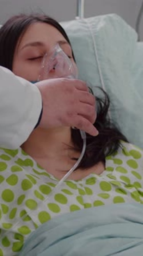Vertical Video Close Up of Medical Doctor Putting Oxigen Mask to Sick Woman