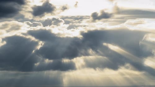 Sunlight Piercing Through Billowing Dark Clouds