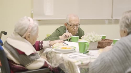 Seniors Eating Together at a Table in a Care Facility