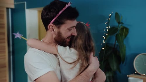 Loving Father and Daughter Embracing Indoors