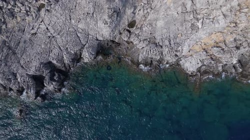 Rocky Coastline Meets Turquoise Ocean From Above