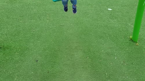 The baby boy are swinging, smiling with happiness and emotion in the outdoor park. Kid boy aged two