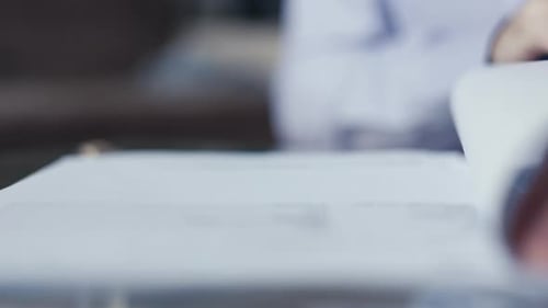Man Signing Legal Documents in Office Close Up