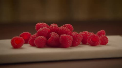 Fresh Red Raspberries Piled on a White Surface