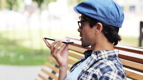 Hispanic man chatting on speakerphone on a sunny city street in Italy