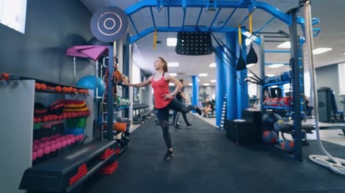 Young woman doing exercise in the sports gym