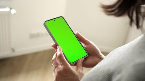 Girl Holding Smartphone With Green Chramakey Screen