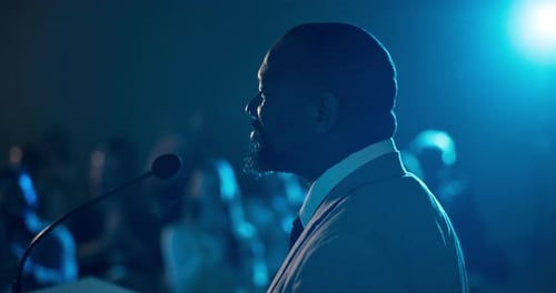 Businessman, podium and applause with audience in auditorium for presentation or speech in seminar