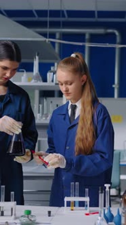 Young Women Working in Laboratory on Scientific Experiment