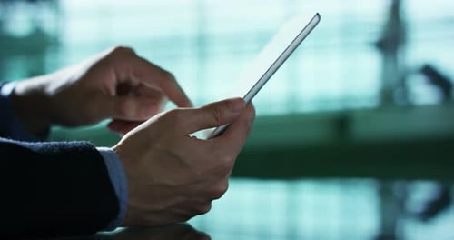 A businessman, writing a message or an e-mail with your tablet for work. The advanced technology t